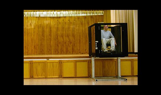 Man using Ascension Protege vertical wheelchair lift to exit a stage
